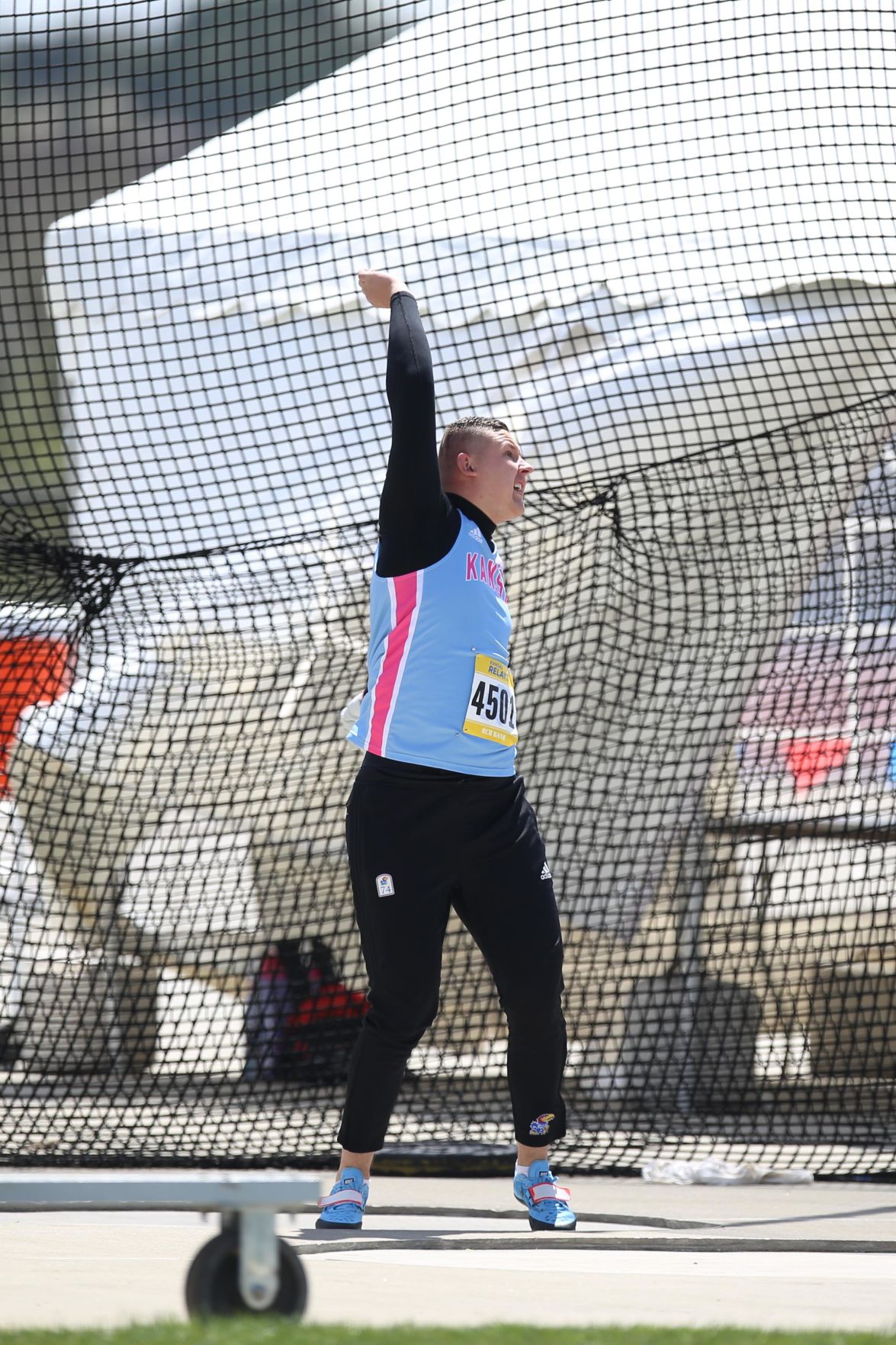 Gleb Dudarev swings his arm up as he finishes the hammer throw at the 2019 Kansas Relays